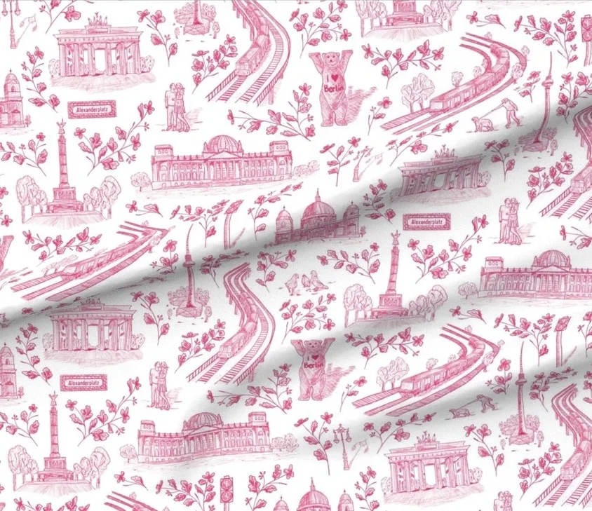 A fabric pattern featuring iconic Berlin landmarks such as the Brandenburg Gate and the TV Tower, surrounded by floral elements and illustrations of a bear, symbolizing Berlin.