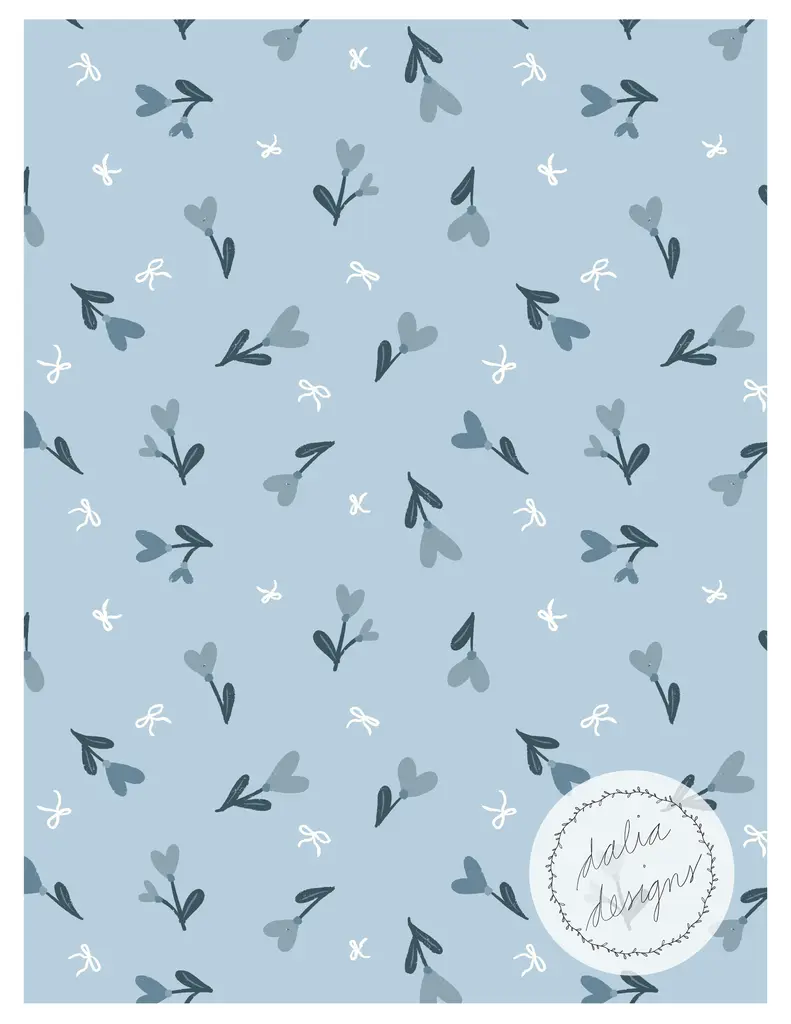 A seamless patterned background featuring small light blue flowers with dark green leaves and white bows on a soft blue backdrop. The design includes a circular logo that reads 'dalia designs' in a handwritten style.
